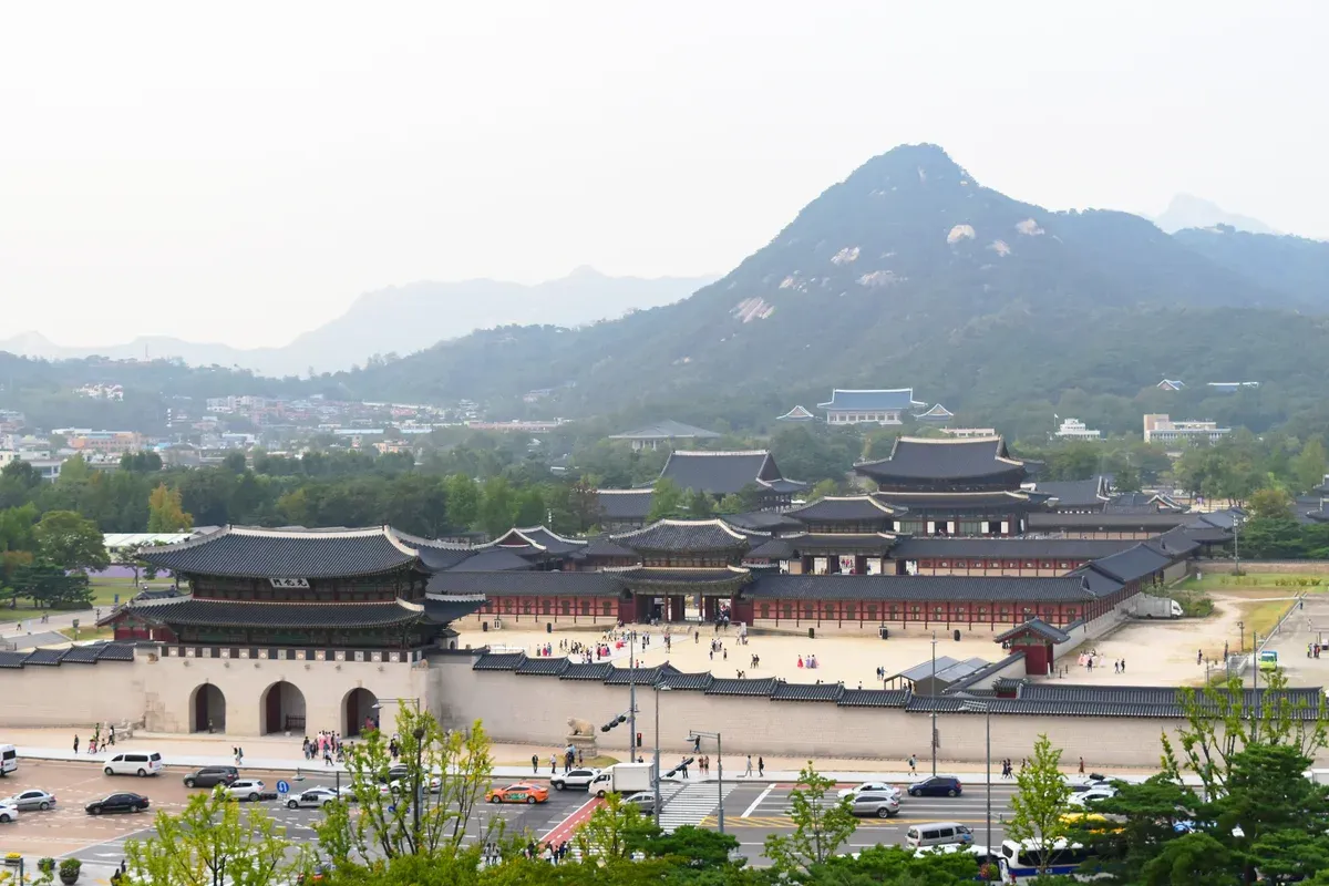 Gwanghwamun gate and the Gyeongbokgung halls below Bugaksan mountain, seen before a Gyeongbokgung palace tour